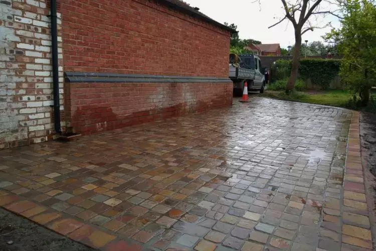 Driveway landscaping project finished. Granite setts block paving with block edge border has been installed to extend and link to an existing driveway.