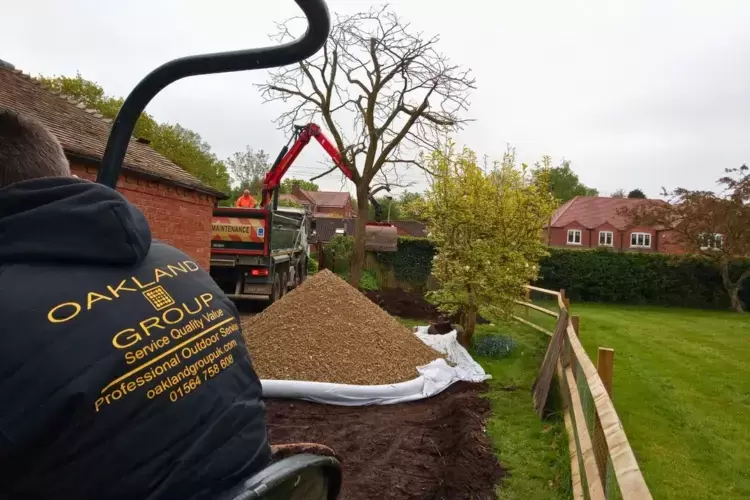 Groundworks are being performed on this driveway landscaping project. Groundswork is being carried out to extend the existing driveway with granite setts block paving.