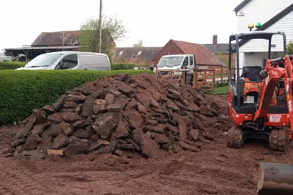 Driveway excavated by Kubota KX015-4 mini-excavator and waste pile ready for removal collection.