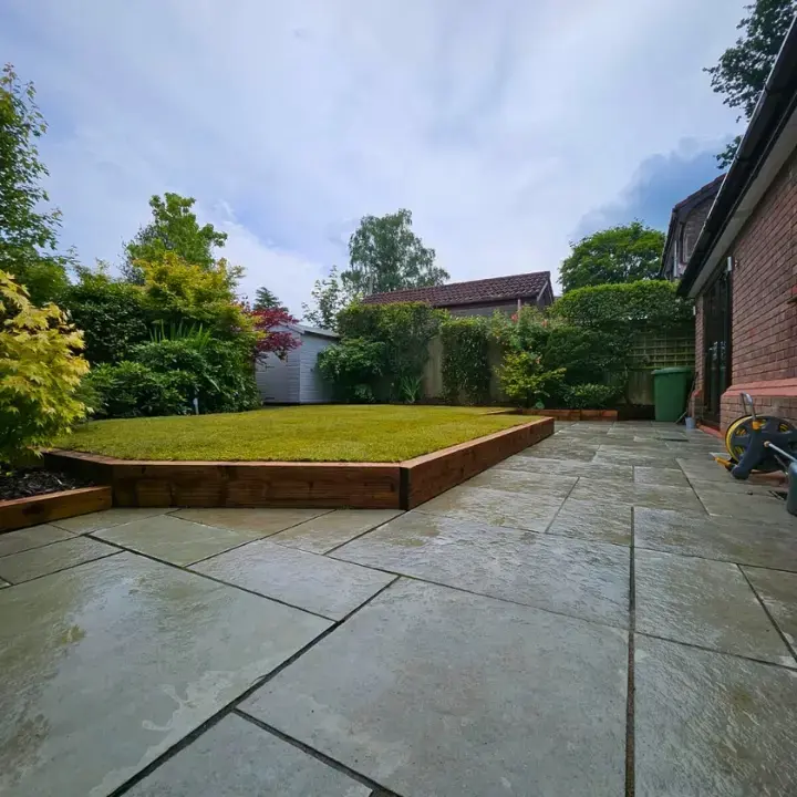 Established garden with patio, raised lawn and sleeper borders set in place around the lawn and patio areas.